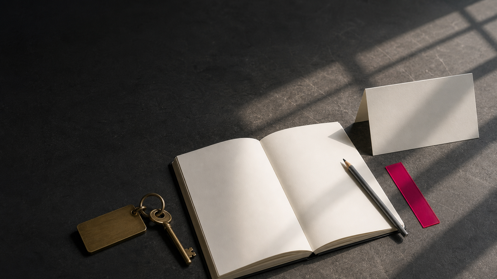 An open guest ledger and room key on dark stone